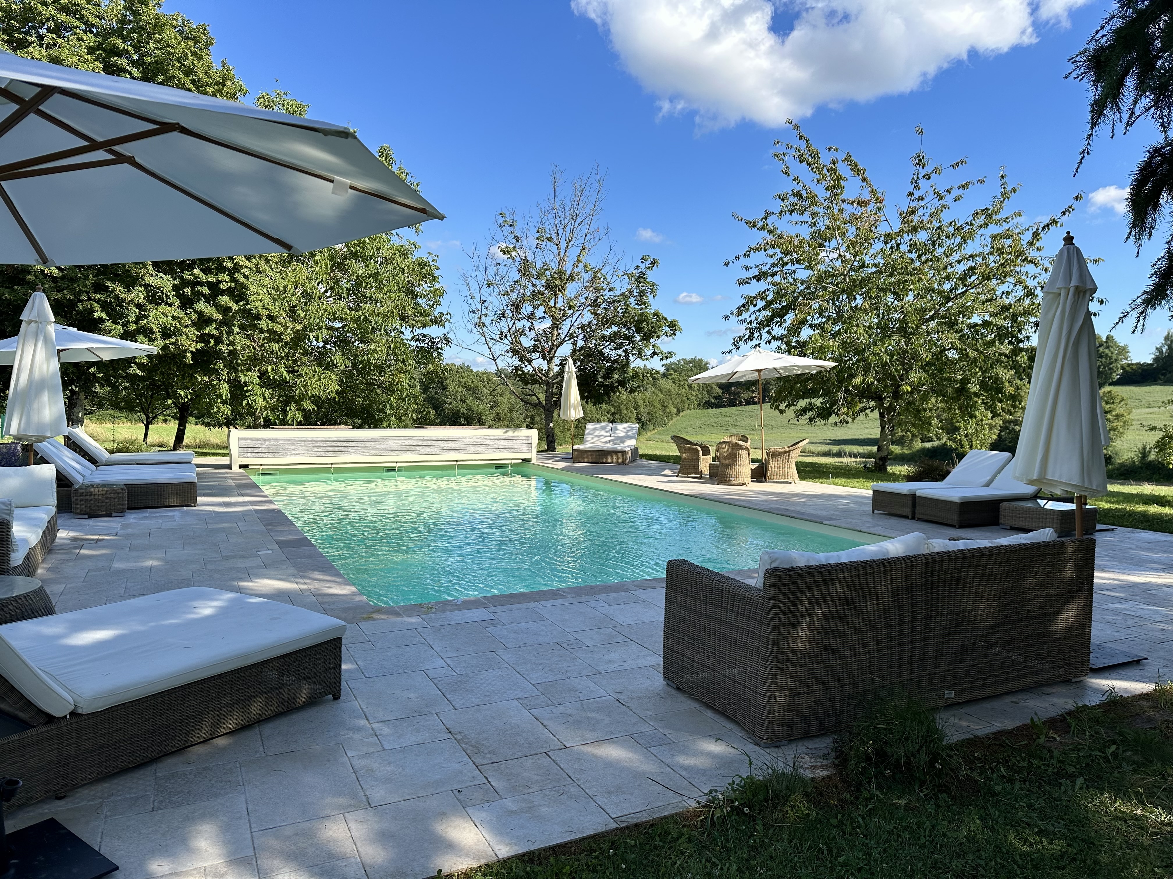 The heated pool at Manoir du Suquet, looking over the meadows