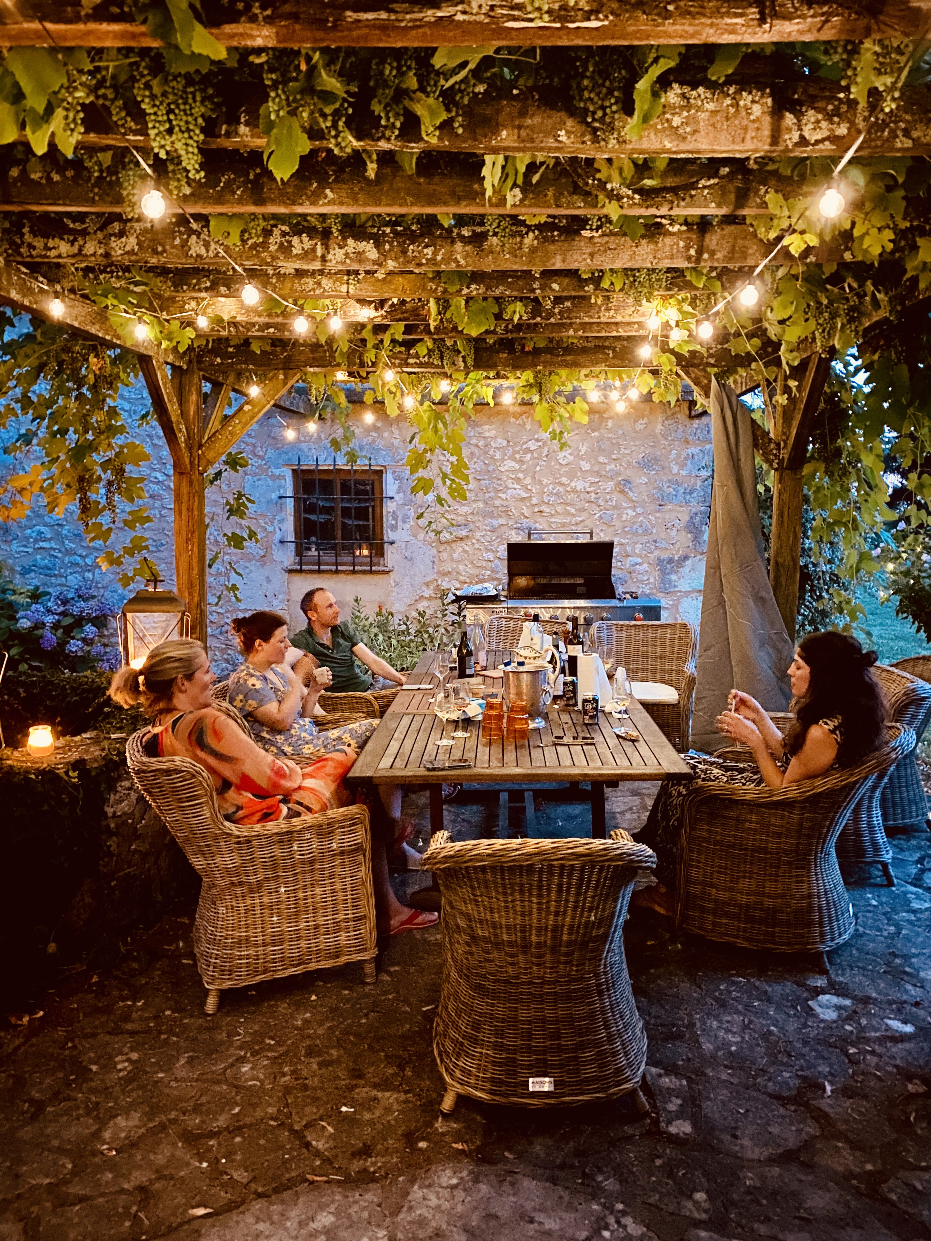 Dinner under the vine-covered terrace at Maison du Seigneur, Manoir du Suquet