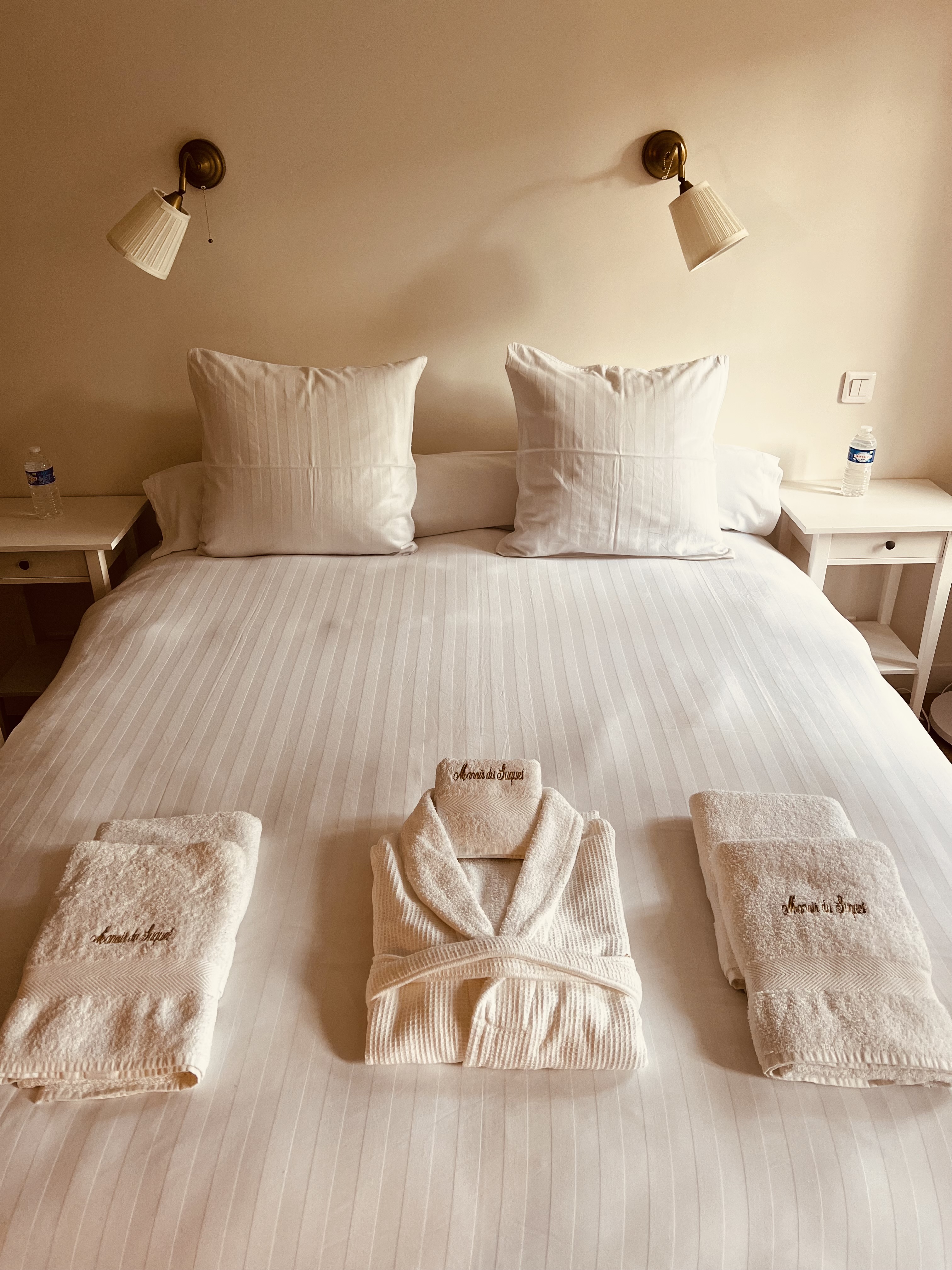 Robes and towels laid out in the master bedroom at Maison du Seigneur