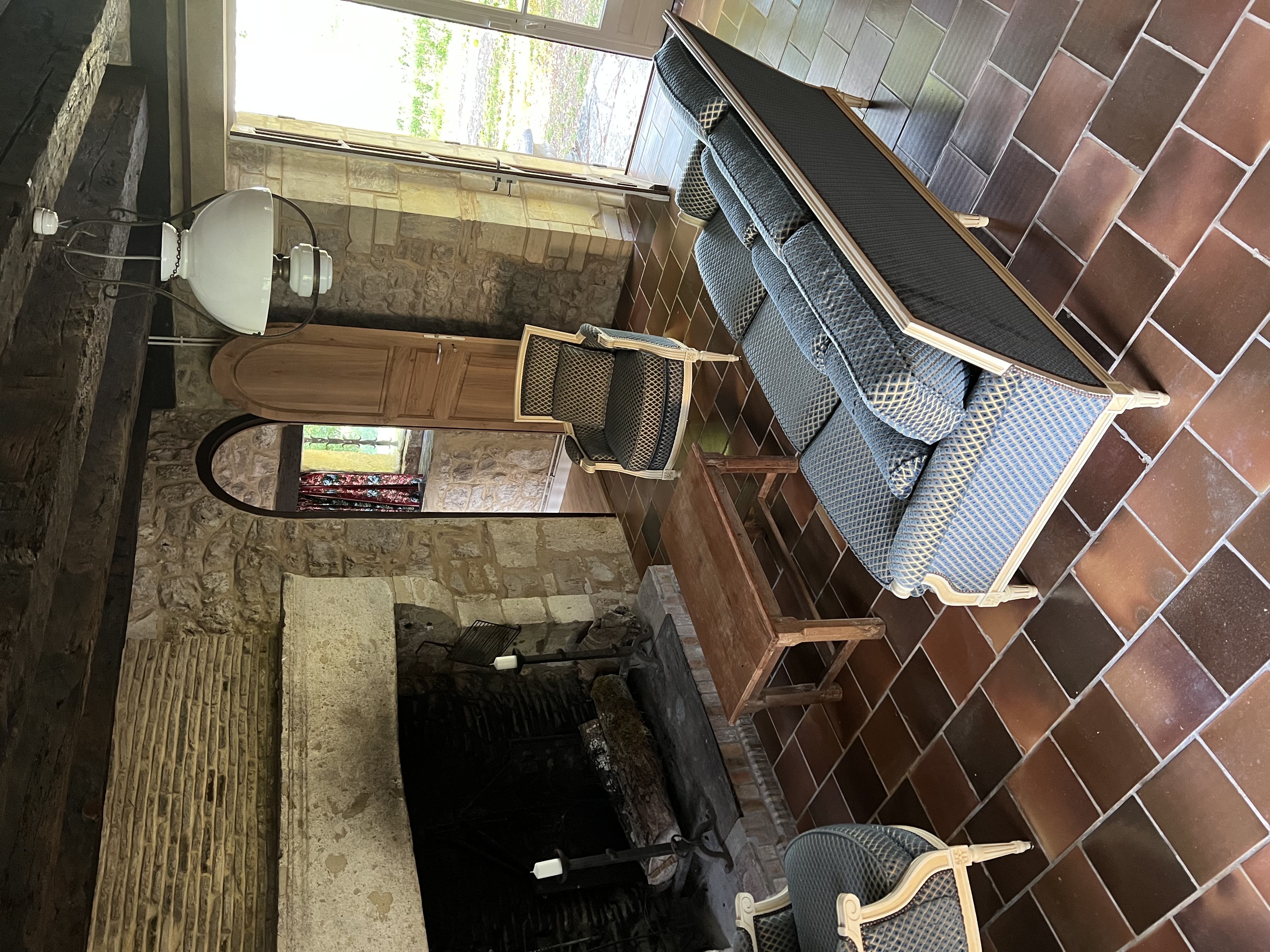 The sitting room at Maison du Seigneur, with its monumental stone fireplace