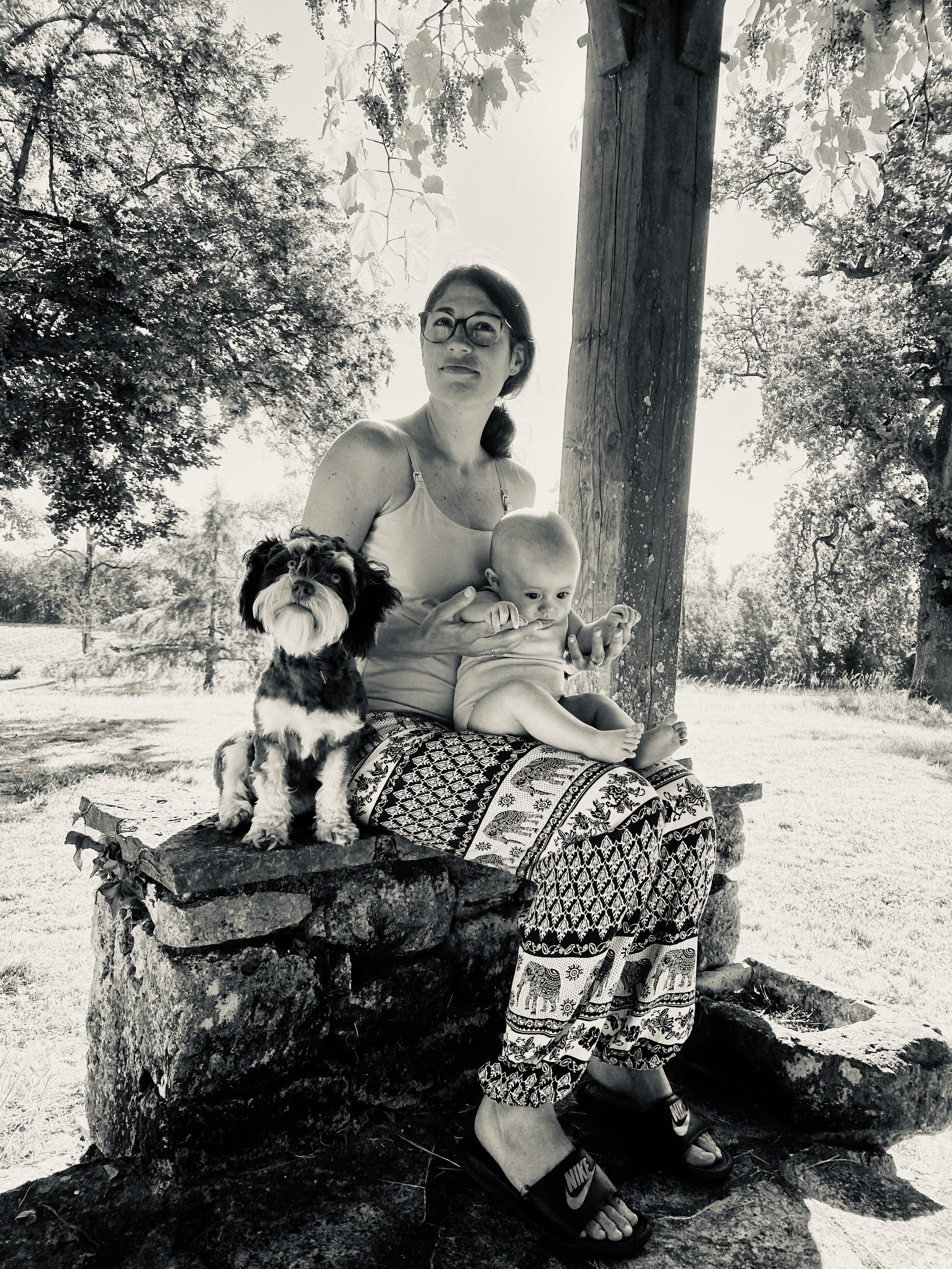 Stephanie with Ruby the Bichon Havanais under the pergola at Le Suquet