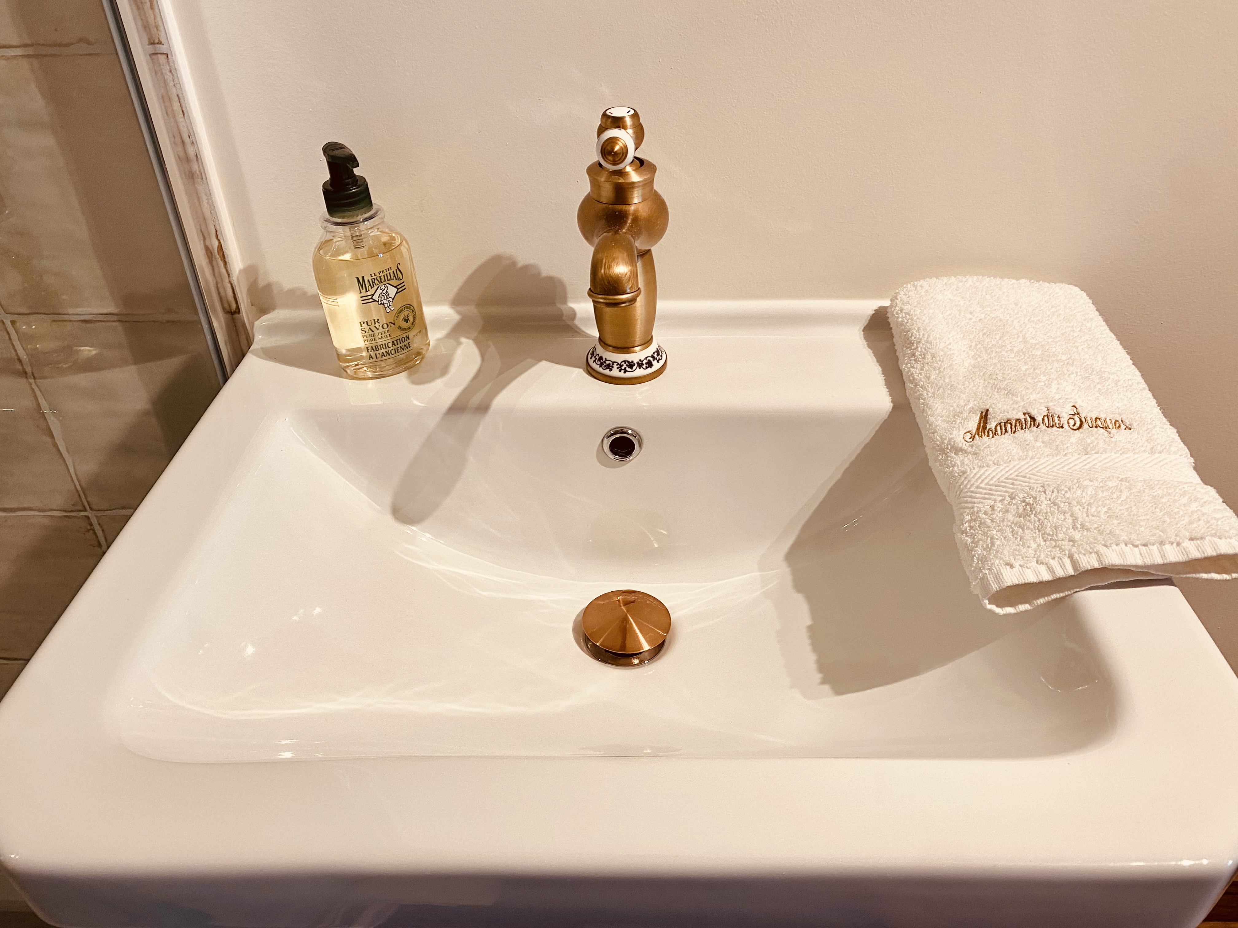 Brass tap and basin in the ground-floor shower room at Maison des Vignes